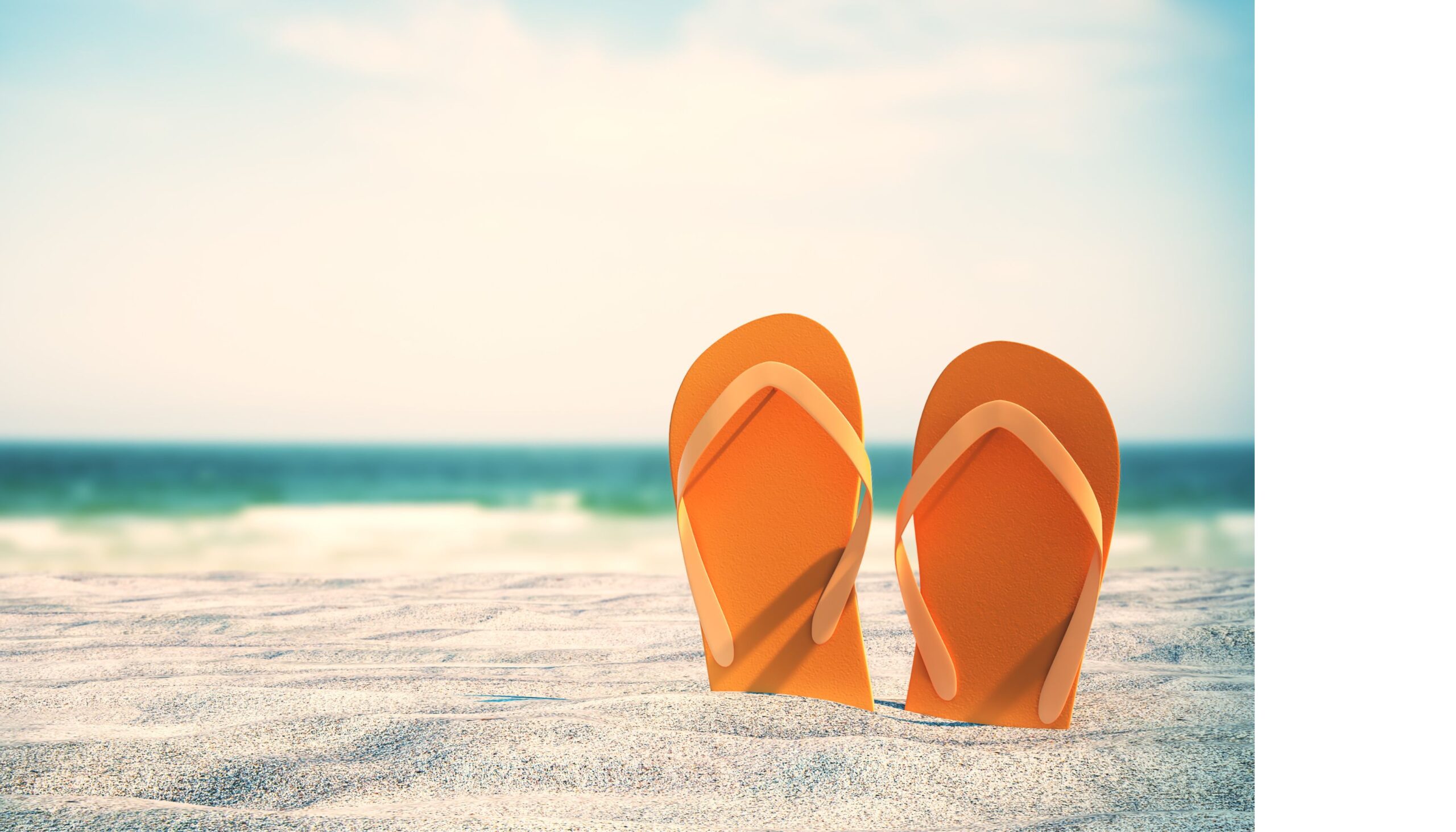 orange flip slops stuck heel down in the beach sand