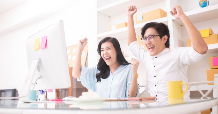 couple sitting at the table cheering