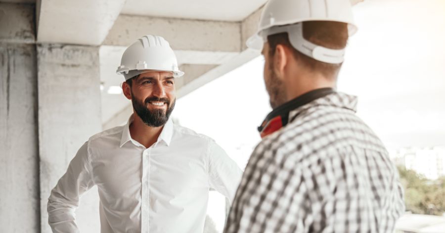 two men in hard hats talking